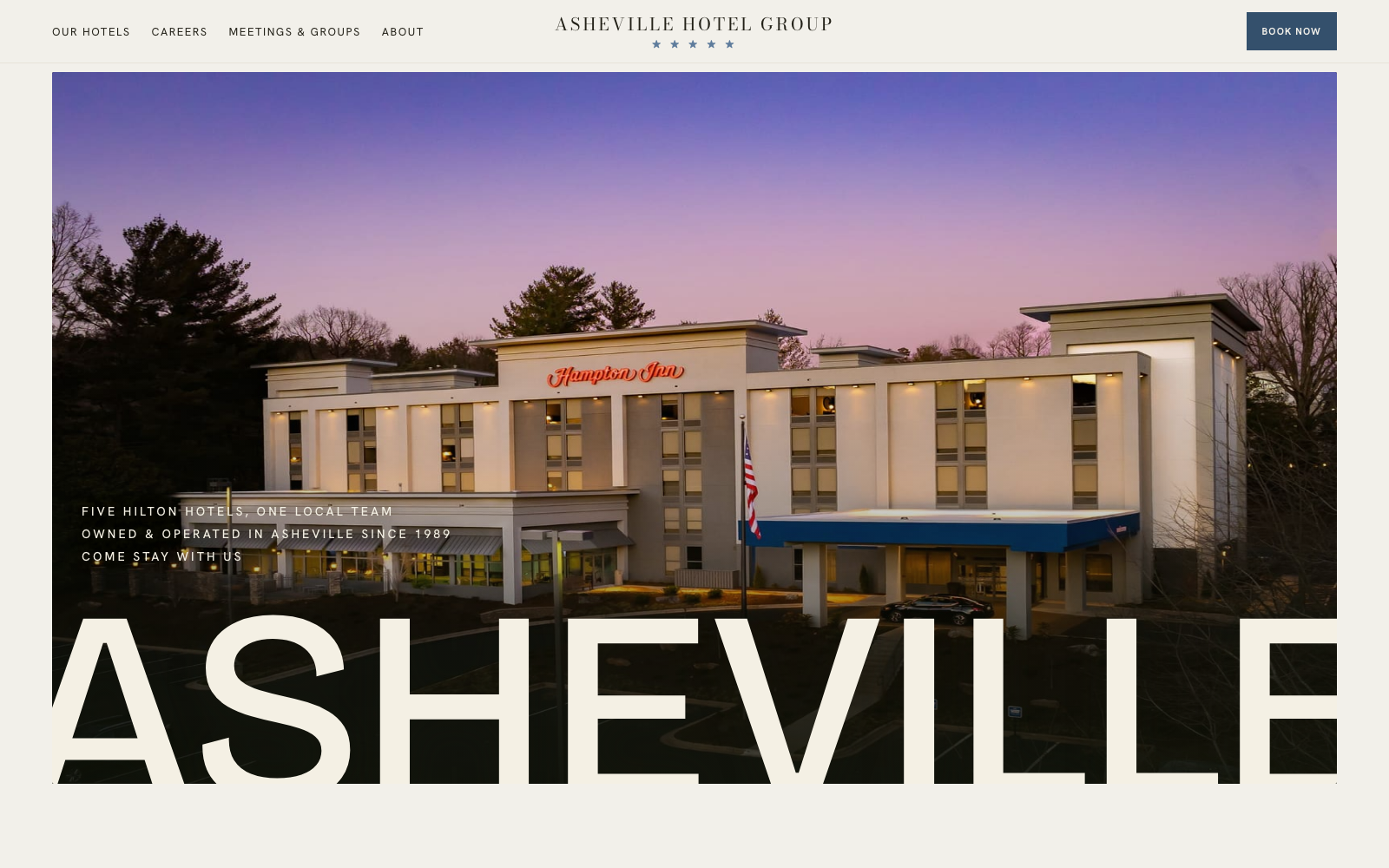 Prototype homepage: Asheville hero over an aerial photo of the Hampton Inn at dusk